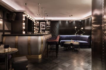 a bar with a blue couch and a blue sofa