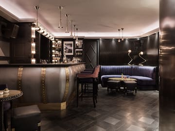 a bar with a blue couch and a blue sofa