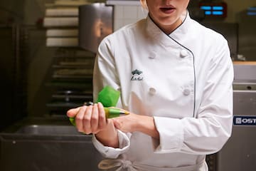 a chef holding a bag of food