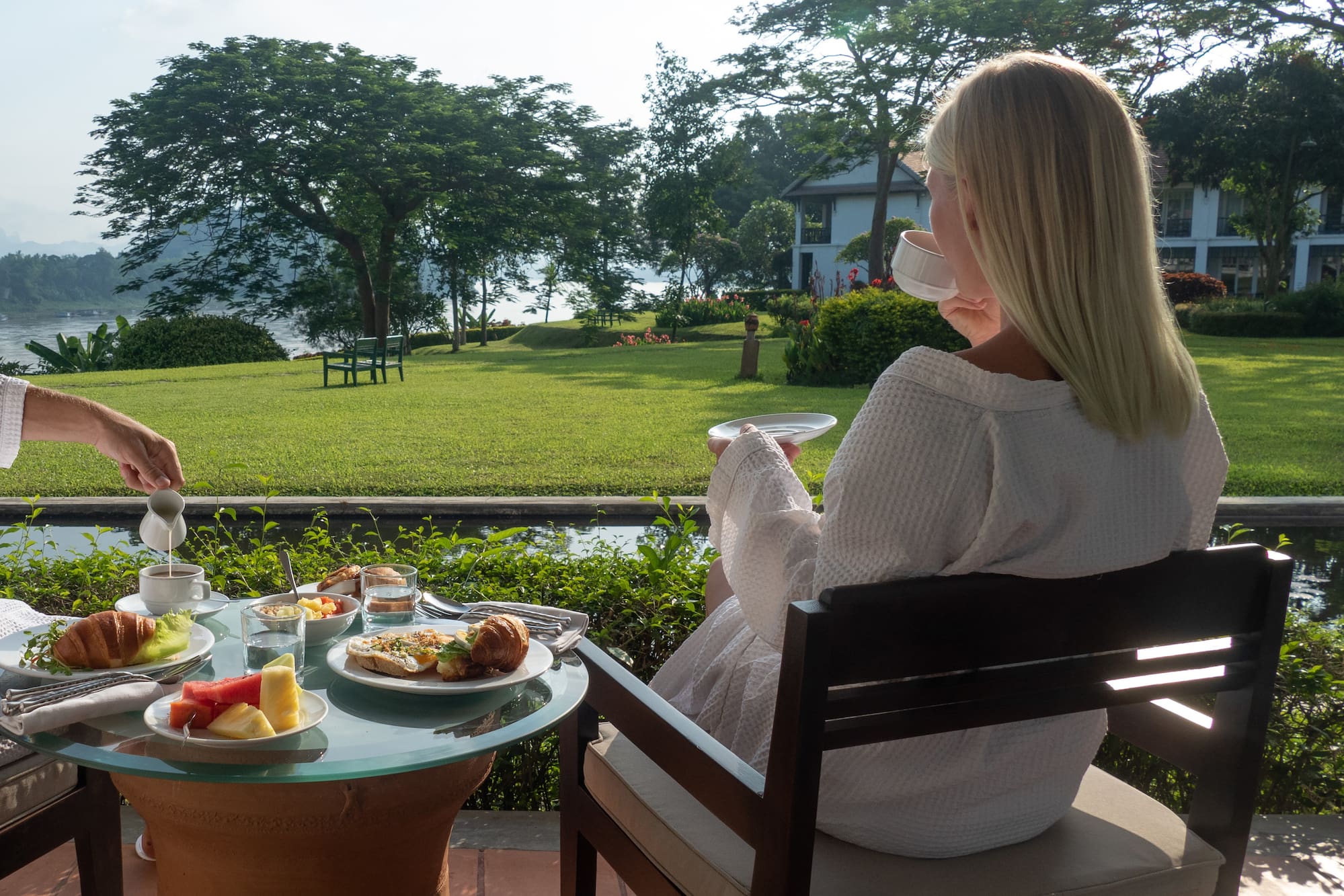 a woman sitting at a table with food on it