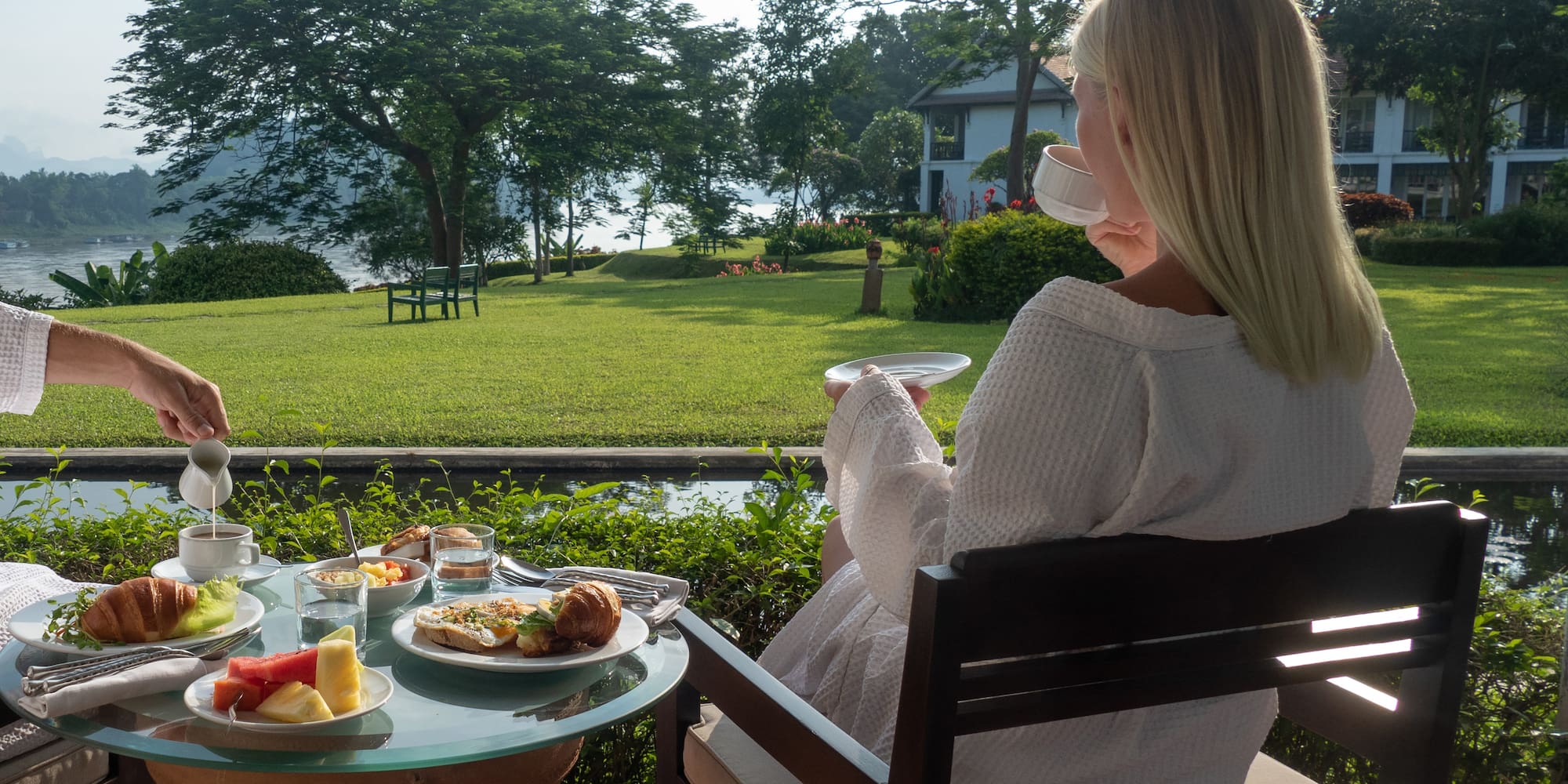 a woman sitting at a table with food on it
