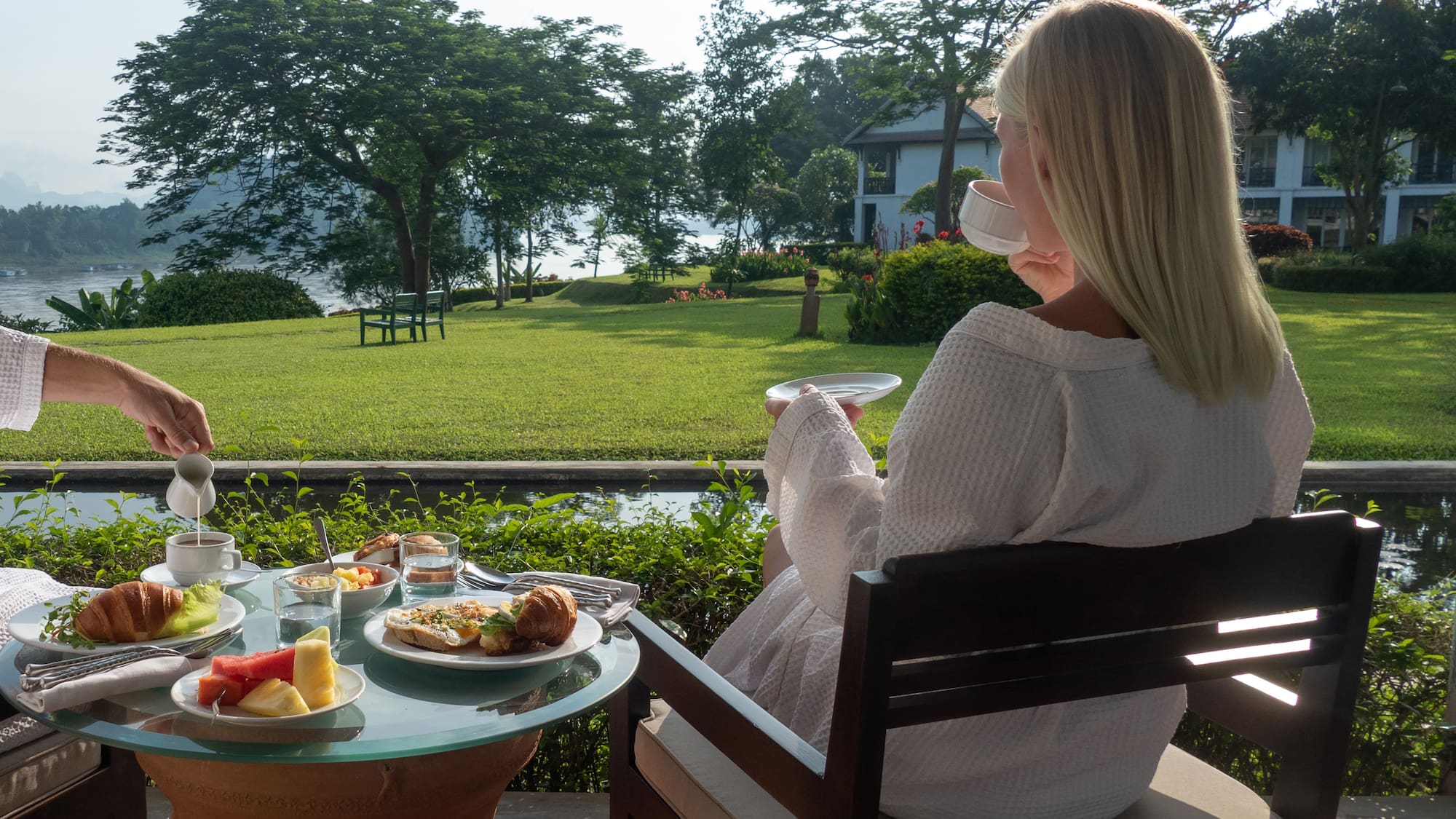 a woman sitting at a table with food on it