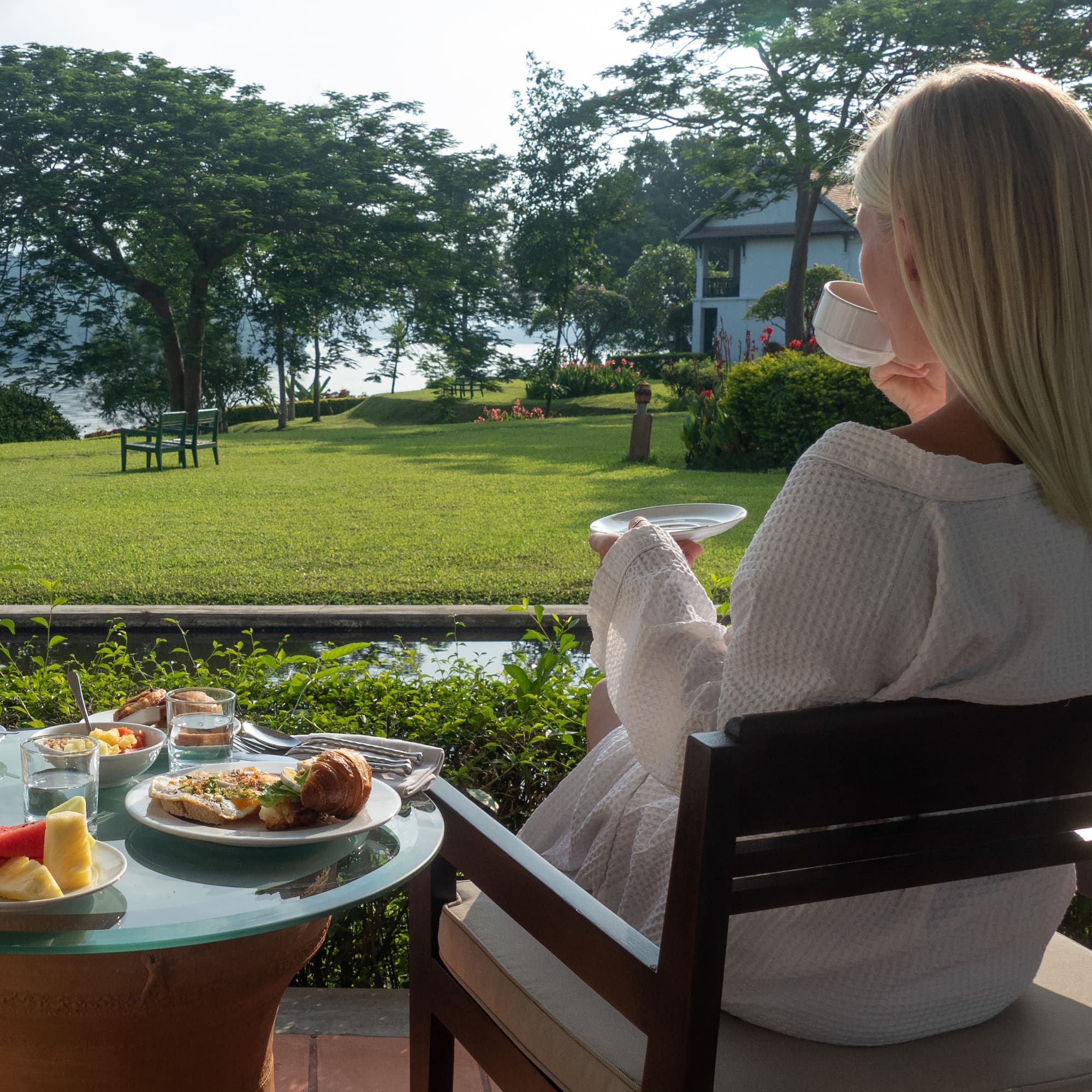 a woman sitting at a table with food on it
