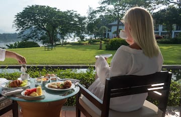 a woman sitting at a table with food on it
