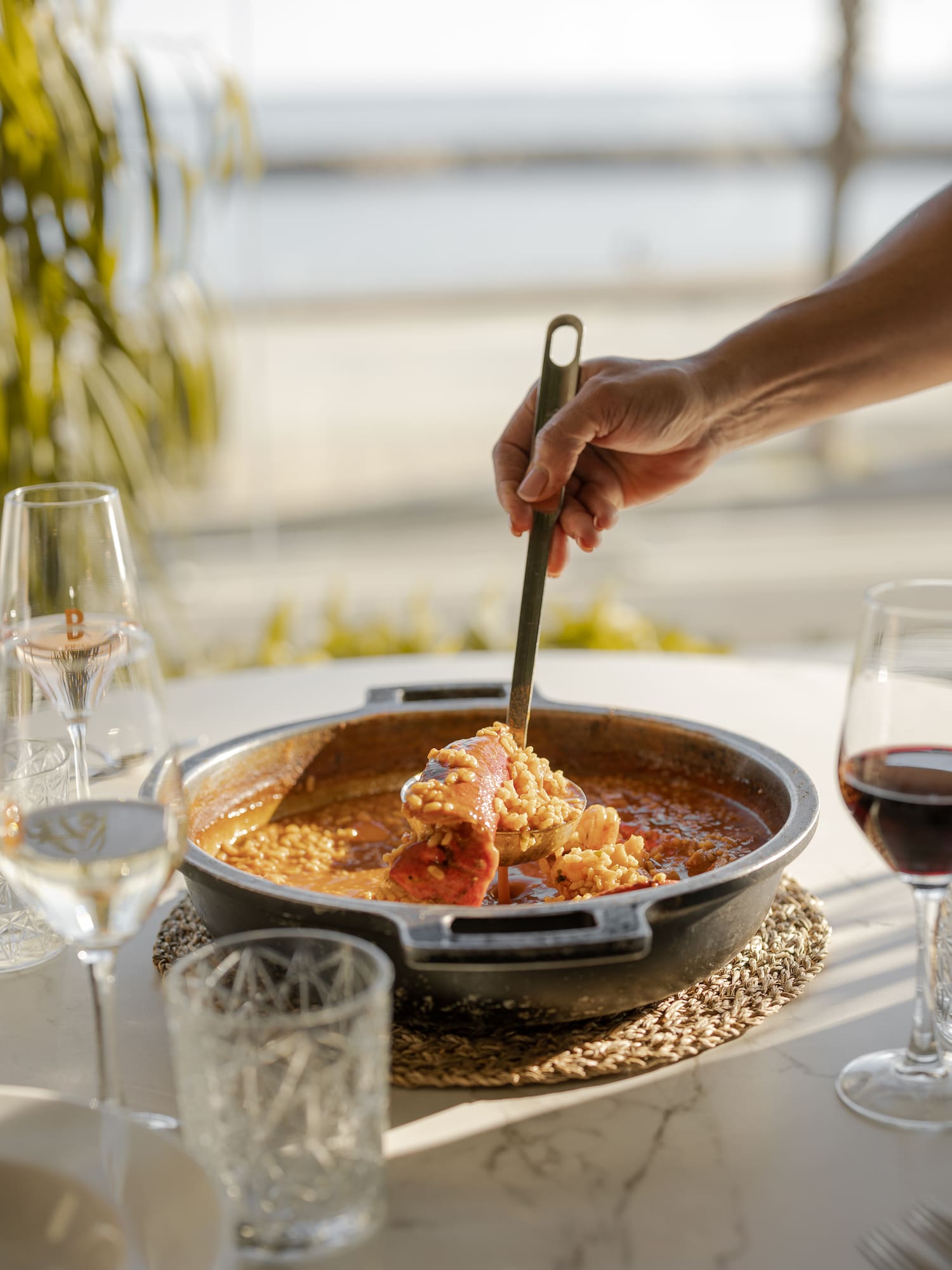 a person holding a spoon over food