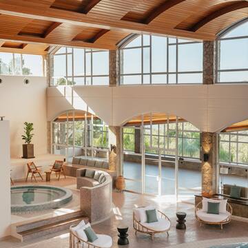 a room with a hot tub and a large pool