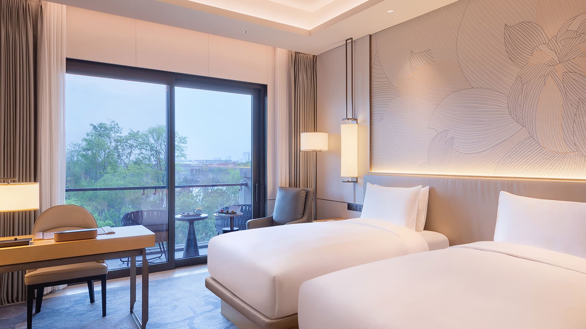 a room with two beds and a table