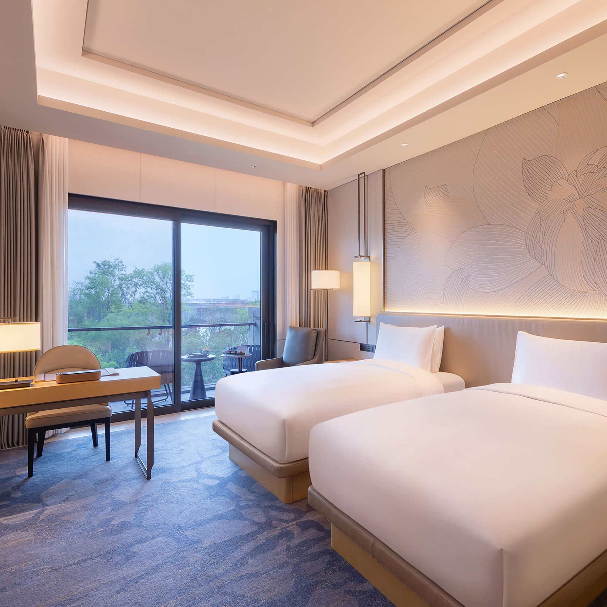 a room with two beds and a table