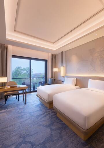 a room with two beds and a table