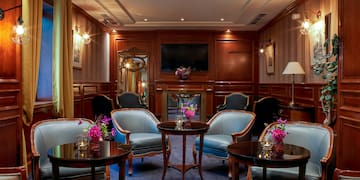 a room with a round table and chairs