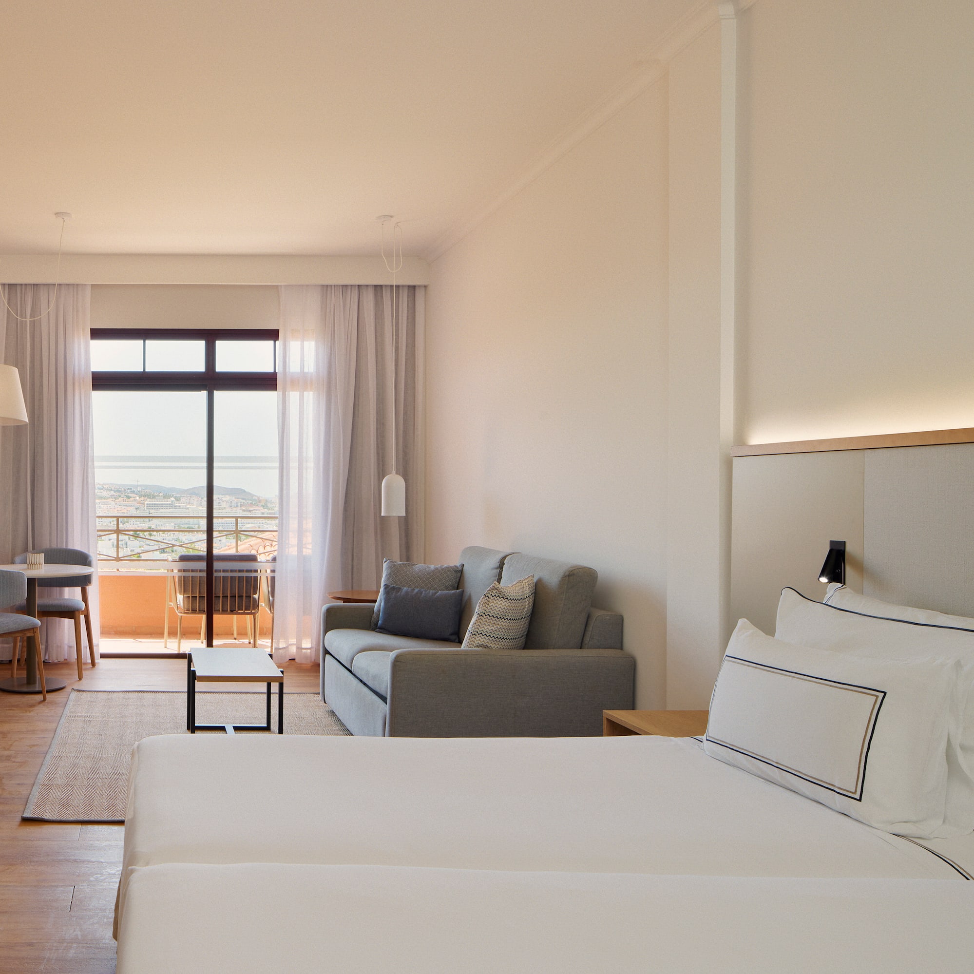 a room with two beds and a couch