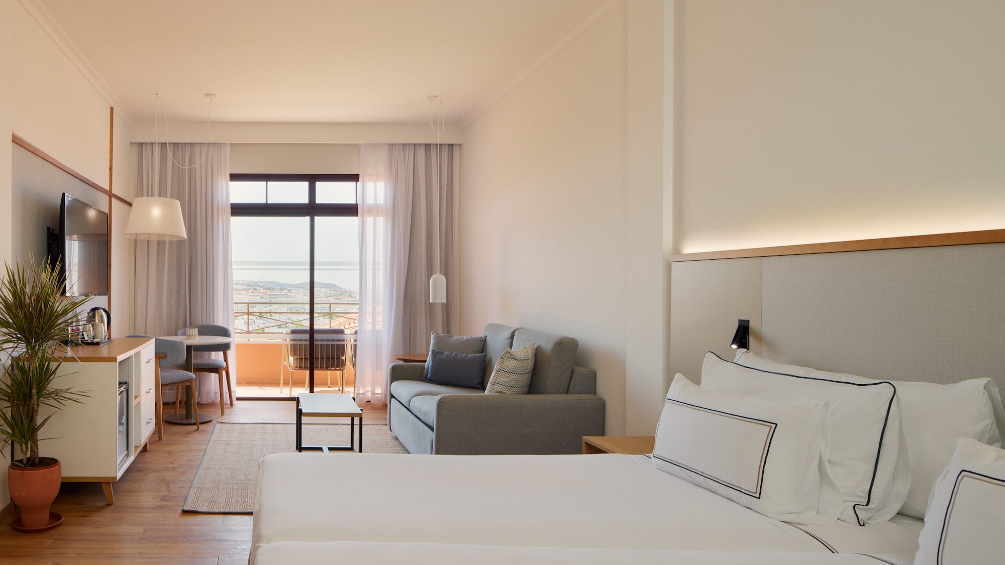 a room with two beds and a couch