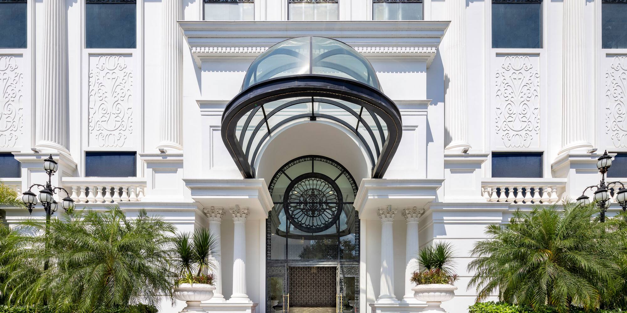 a white building with a glass door and a round window