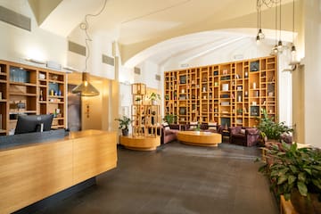 a room with a reception desk and shelves of books