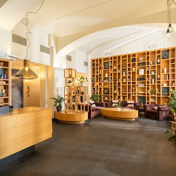 a room with a reception desk and shelves of books