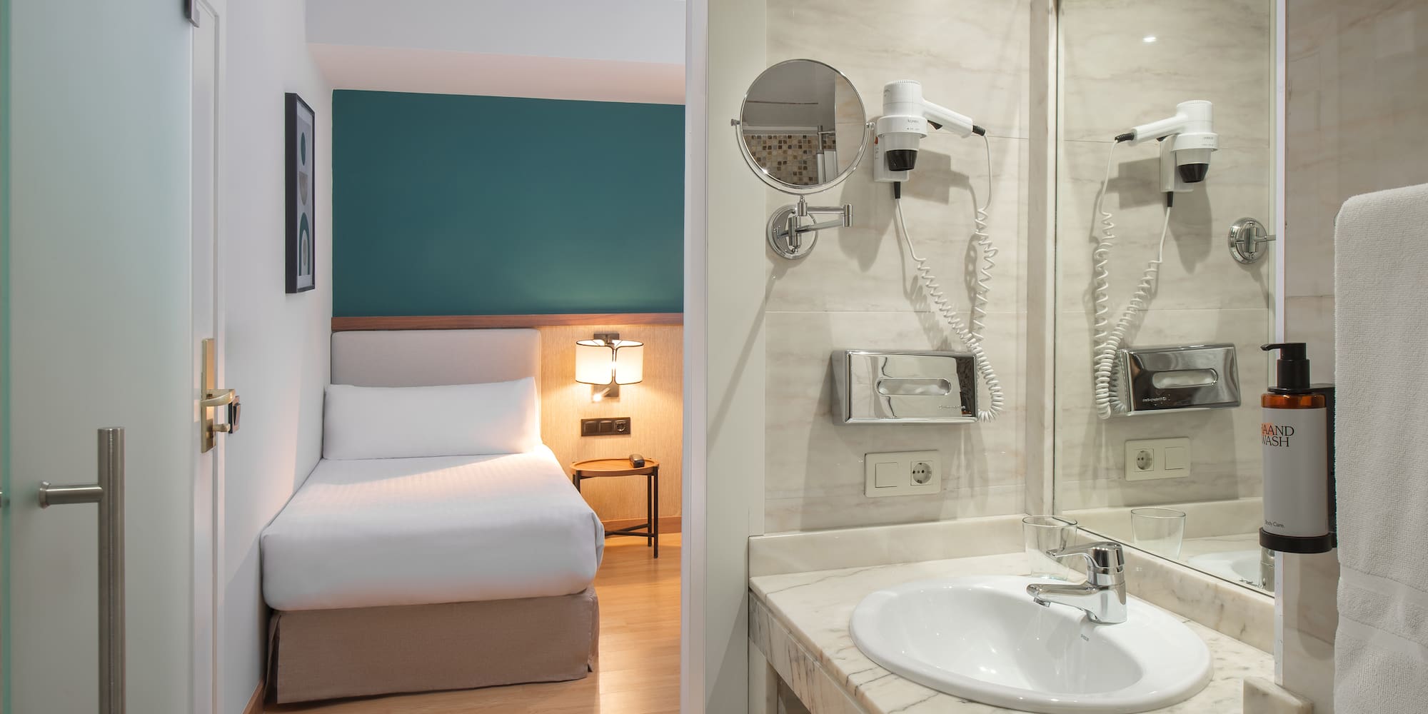 a bathroom with a mirror and a bed