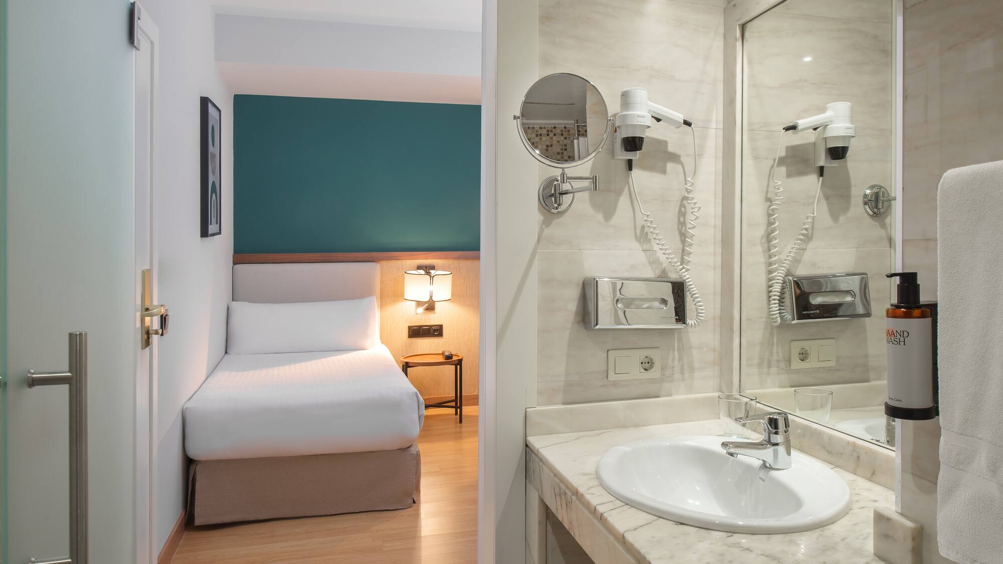 a bathroom with a mirror and a bed