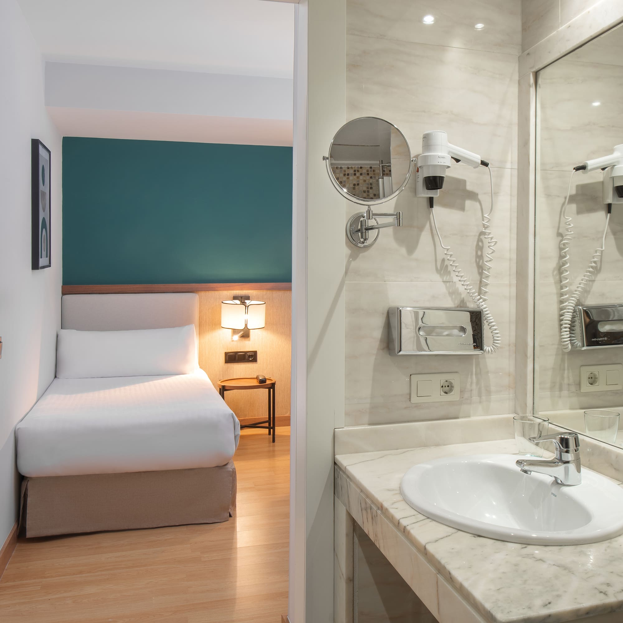 a bathroom with a mirror and a bed