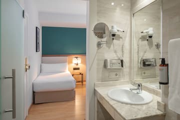 a bathroom with a mirror and a bed