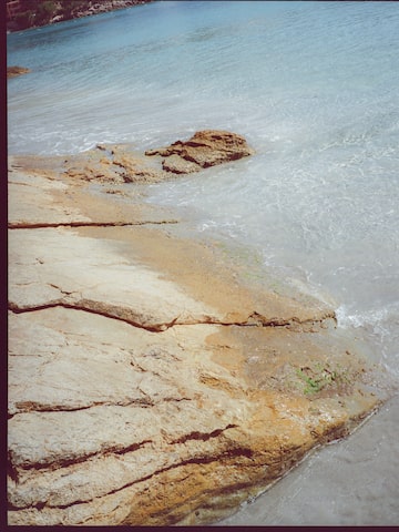 a rocky beach with waves crashing on it