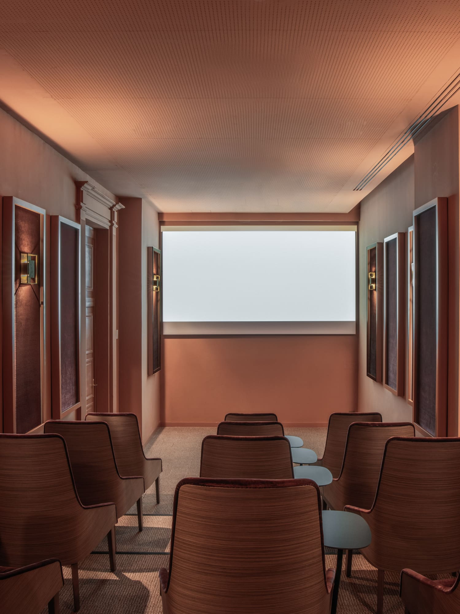 a room with chairs and a large screen