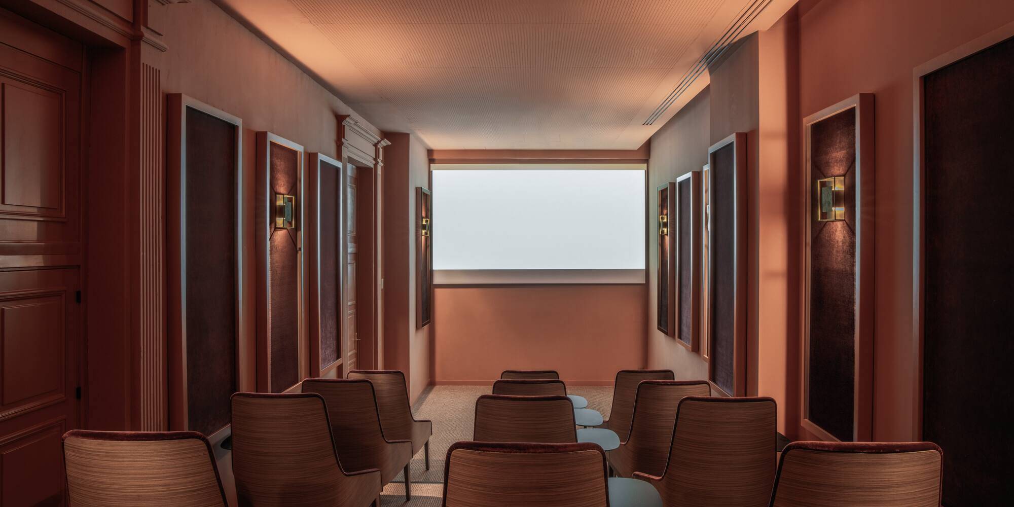 a room with chairs and a large screen