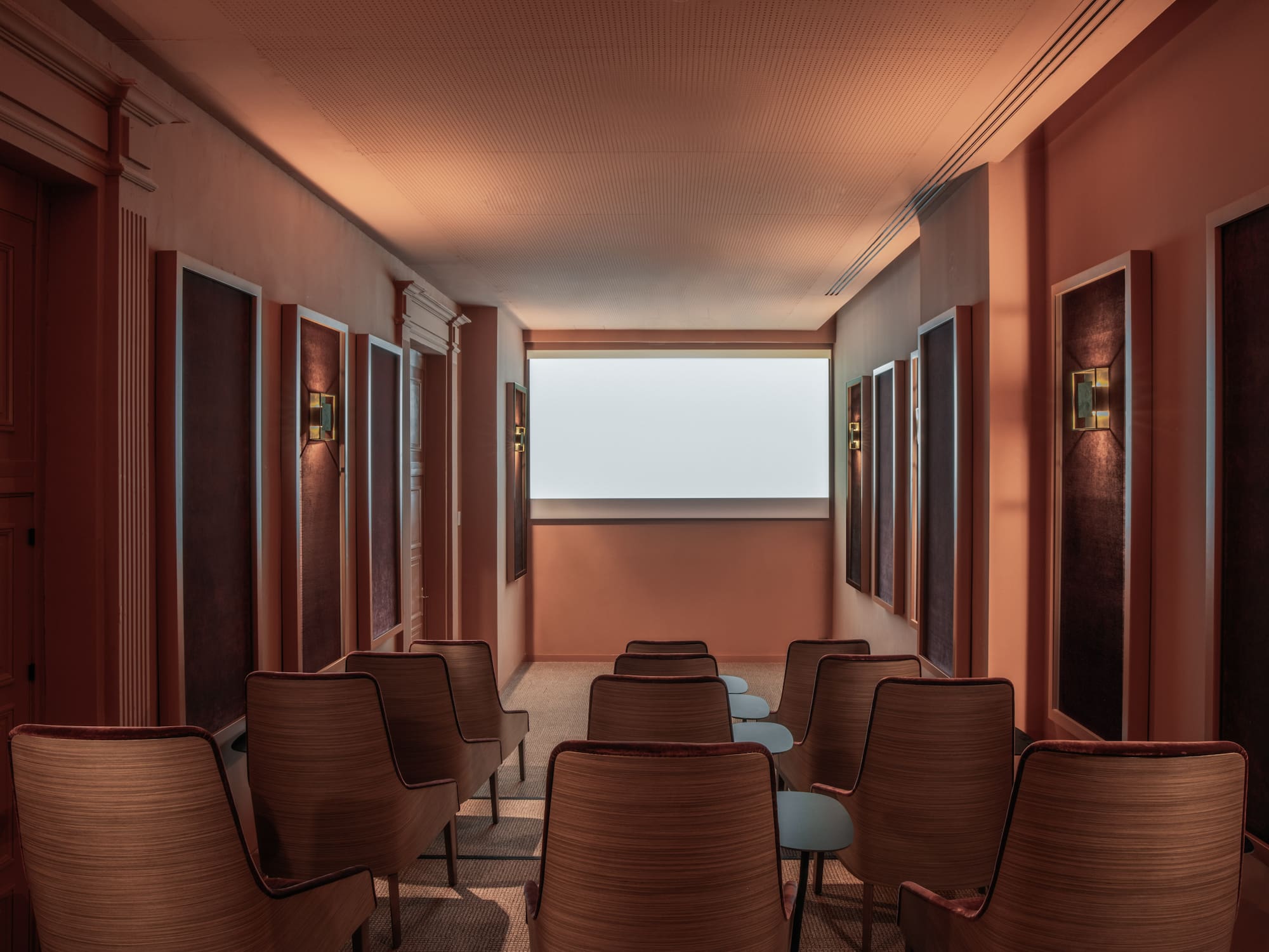 a room with chairs and a large screen