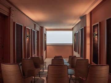 a room with chairs and a large screen