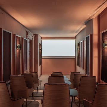 a room with chairs and a large screen
