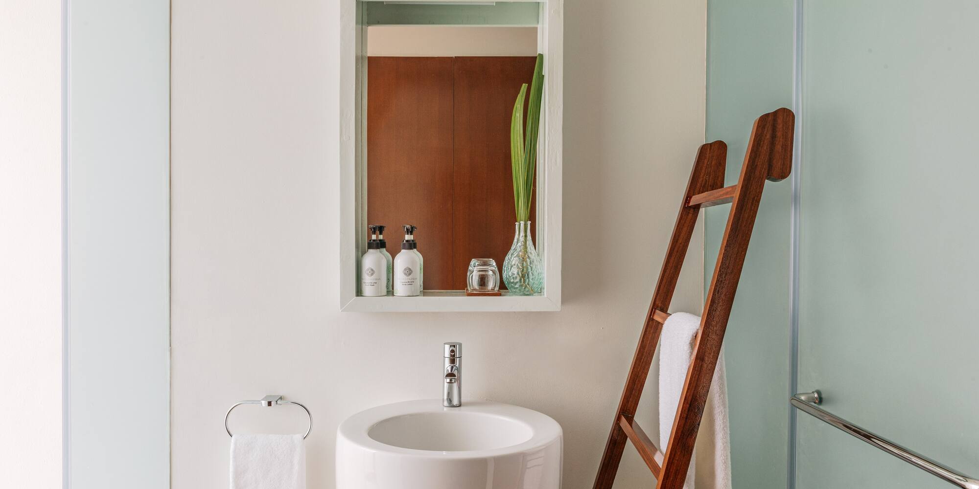 a bathroom with a ladder and a sink