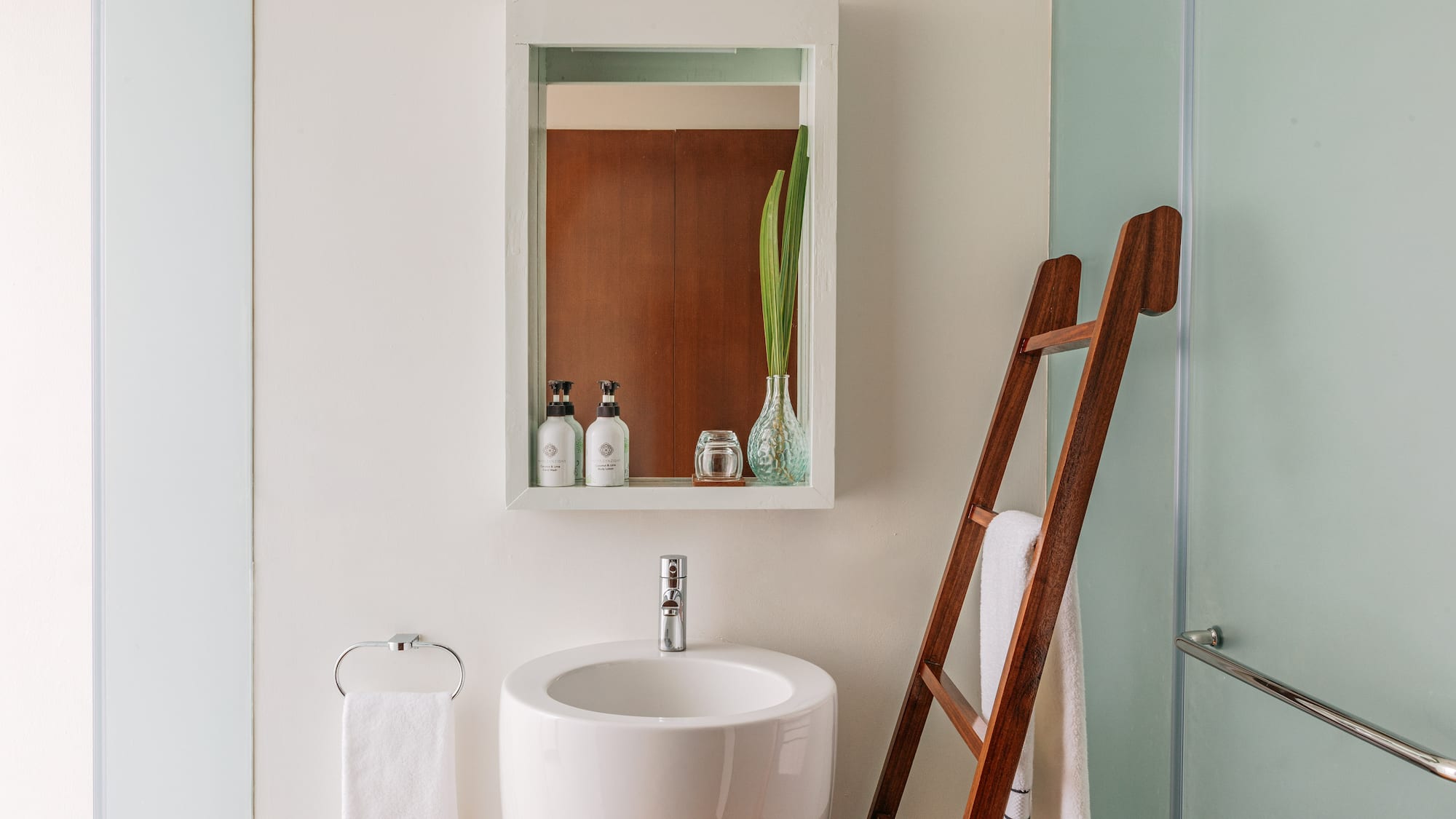 a bathroom with a ladder and a sink