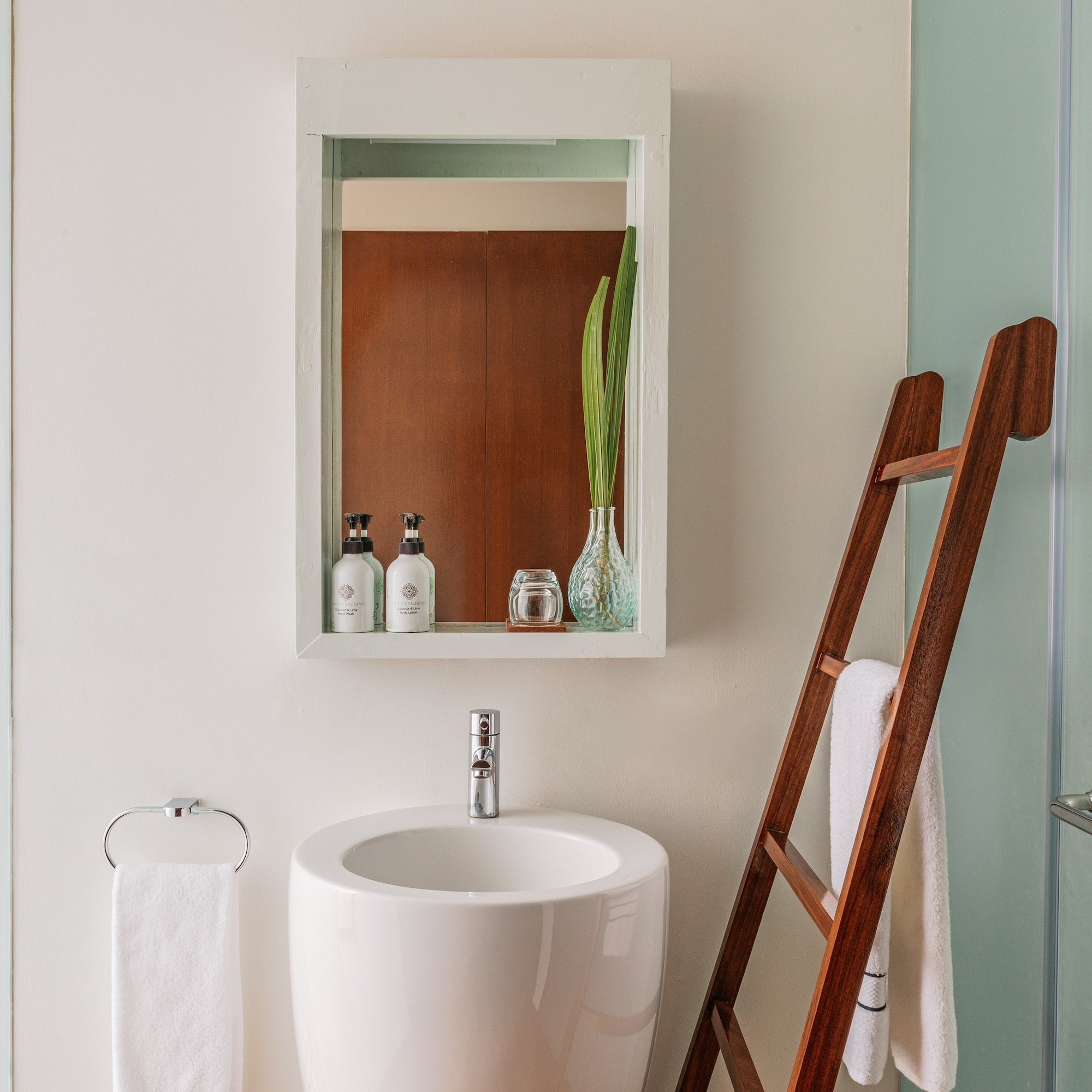 a bathroom with a ladder and a sink