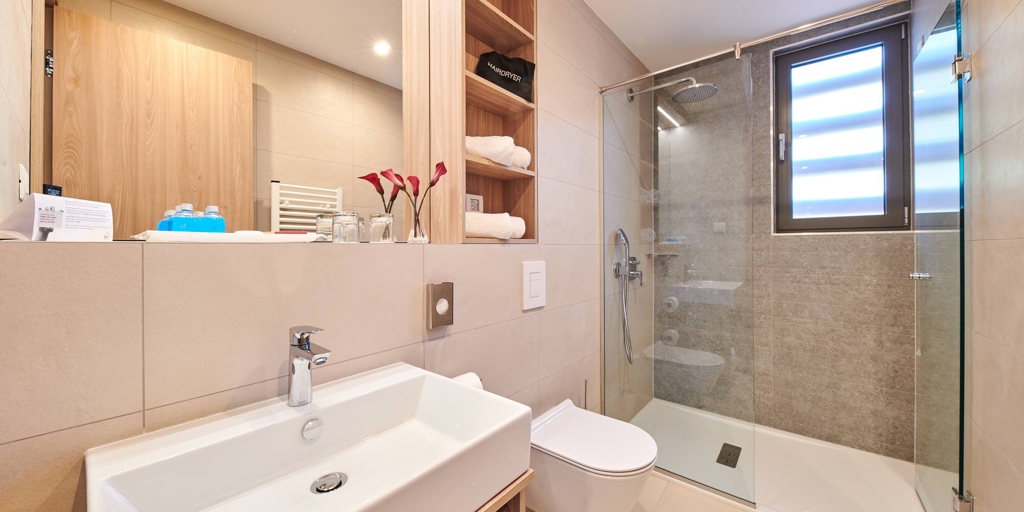 a bathroom with a glass shower and sink
