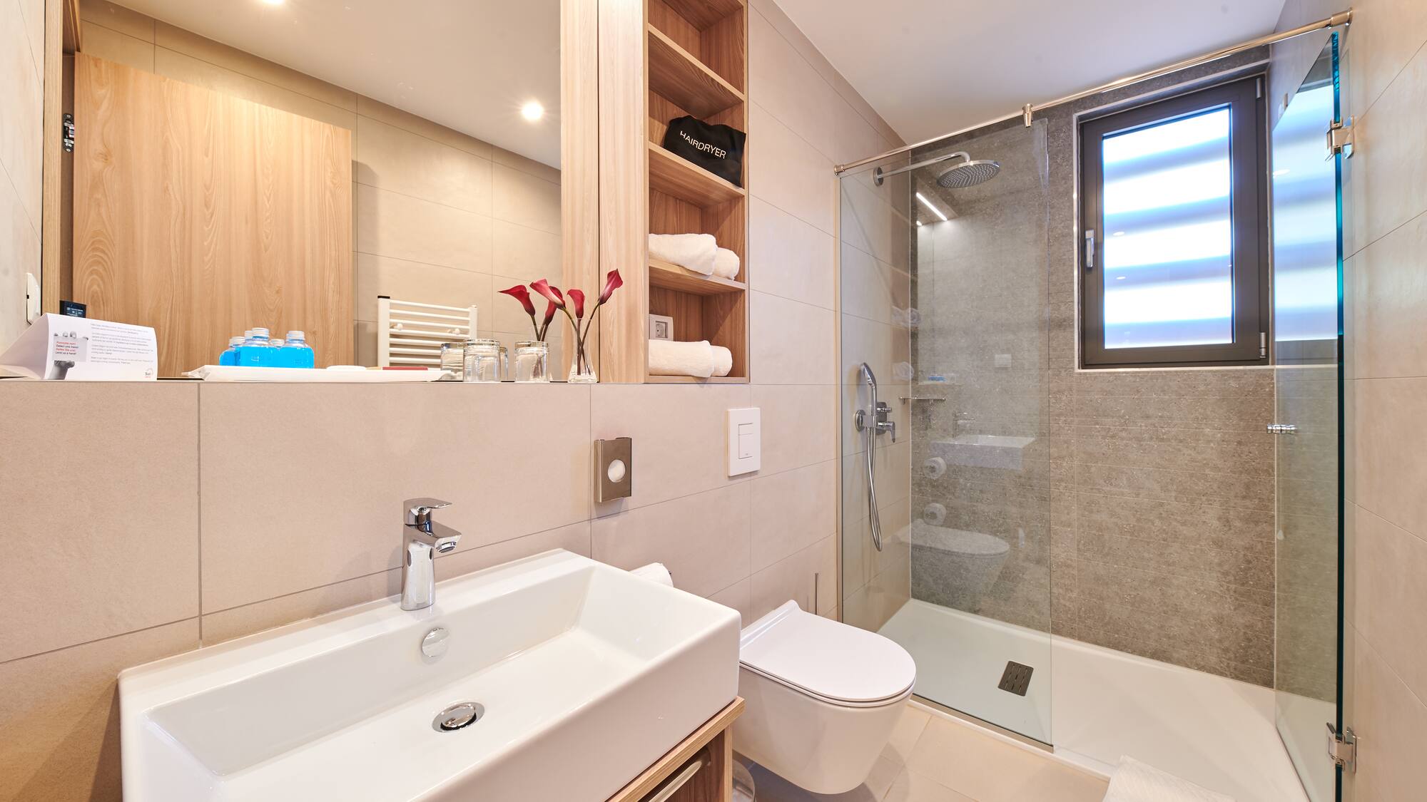 a bathroom with a glass shower and sink