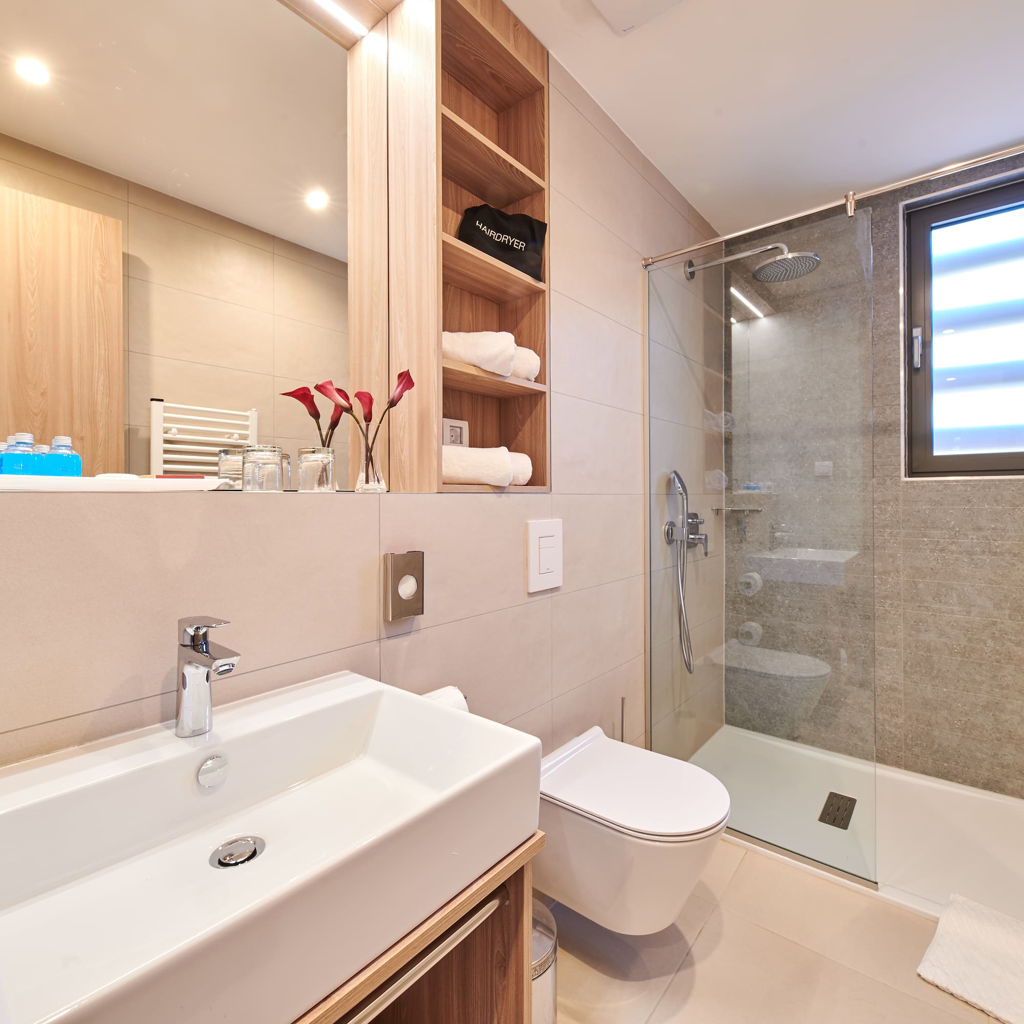 a bathroom with a glass shower and sink