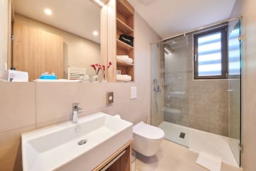 a bathroom with a glass shower and sink