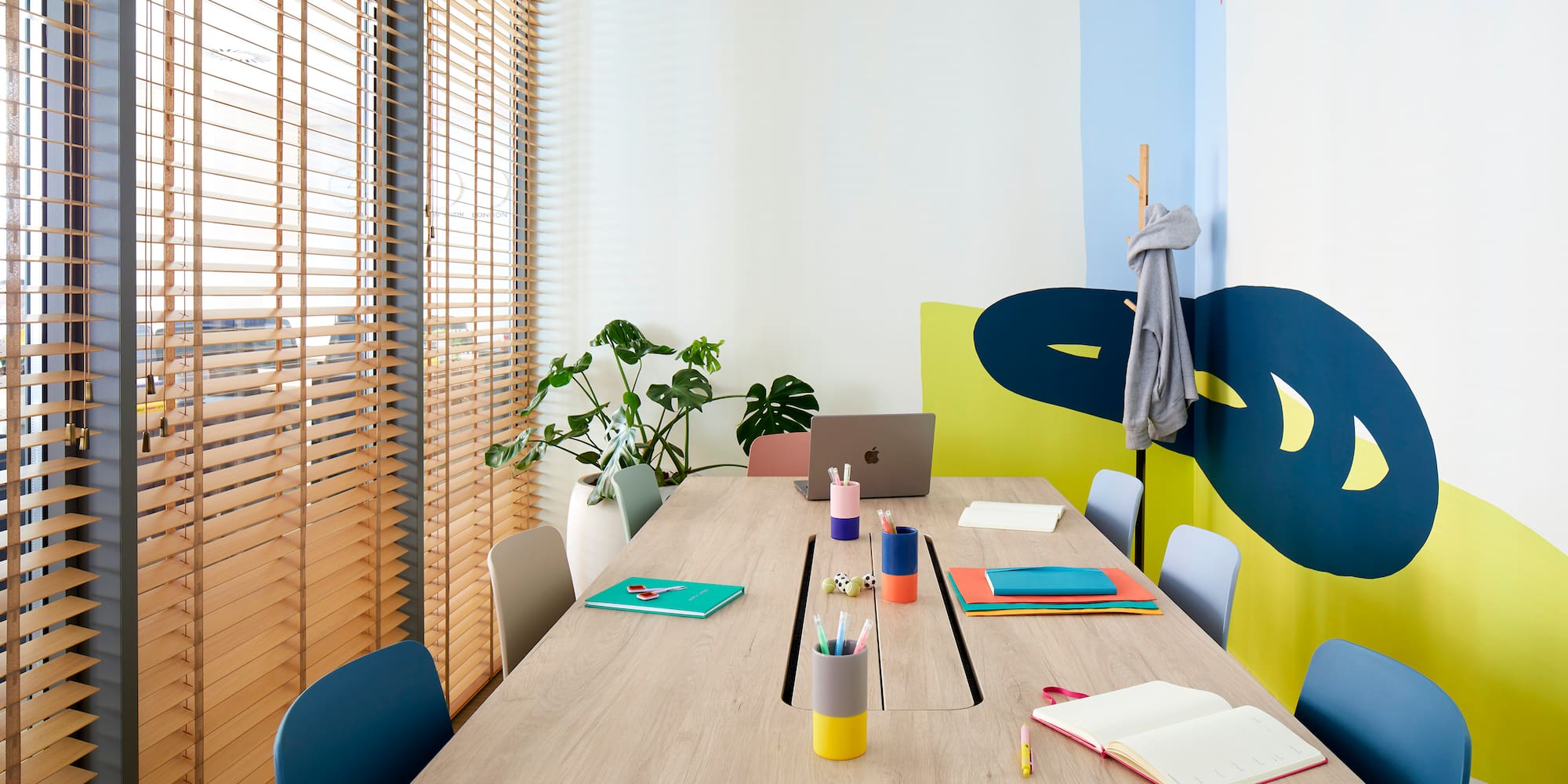 a table with laptop and notebooks on it