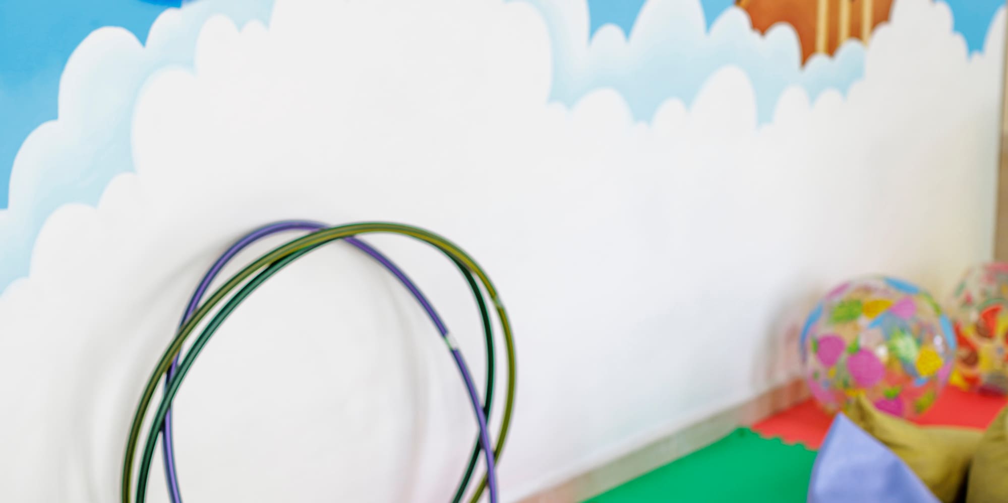 a room with a wall mural and toys