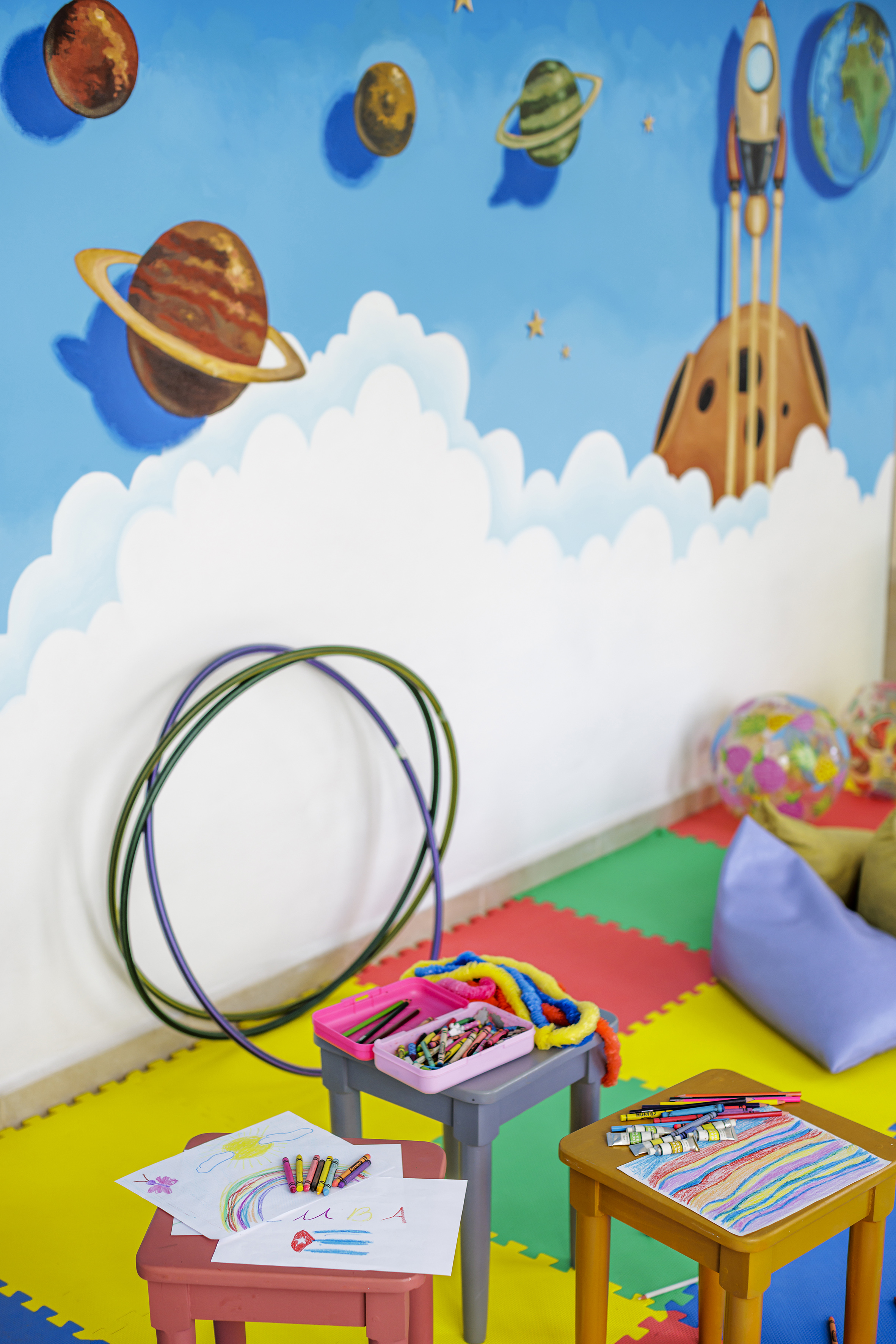 a room with a wall mural and toys