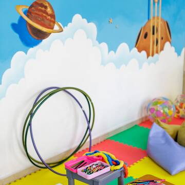 a room with a wall mural and toys