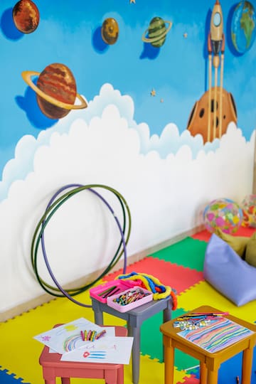 a room with a wall mural and toys