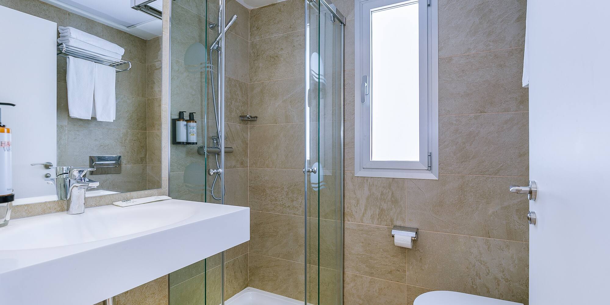 a bathroom with a glass shower and toilet