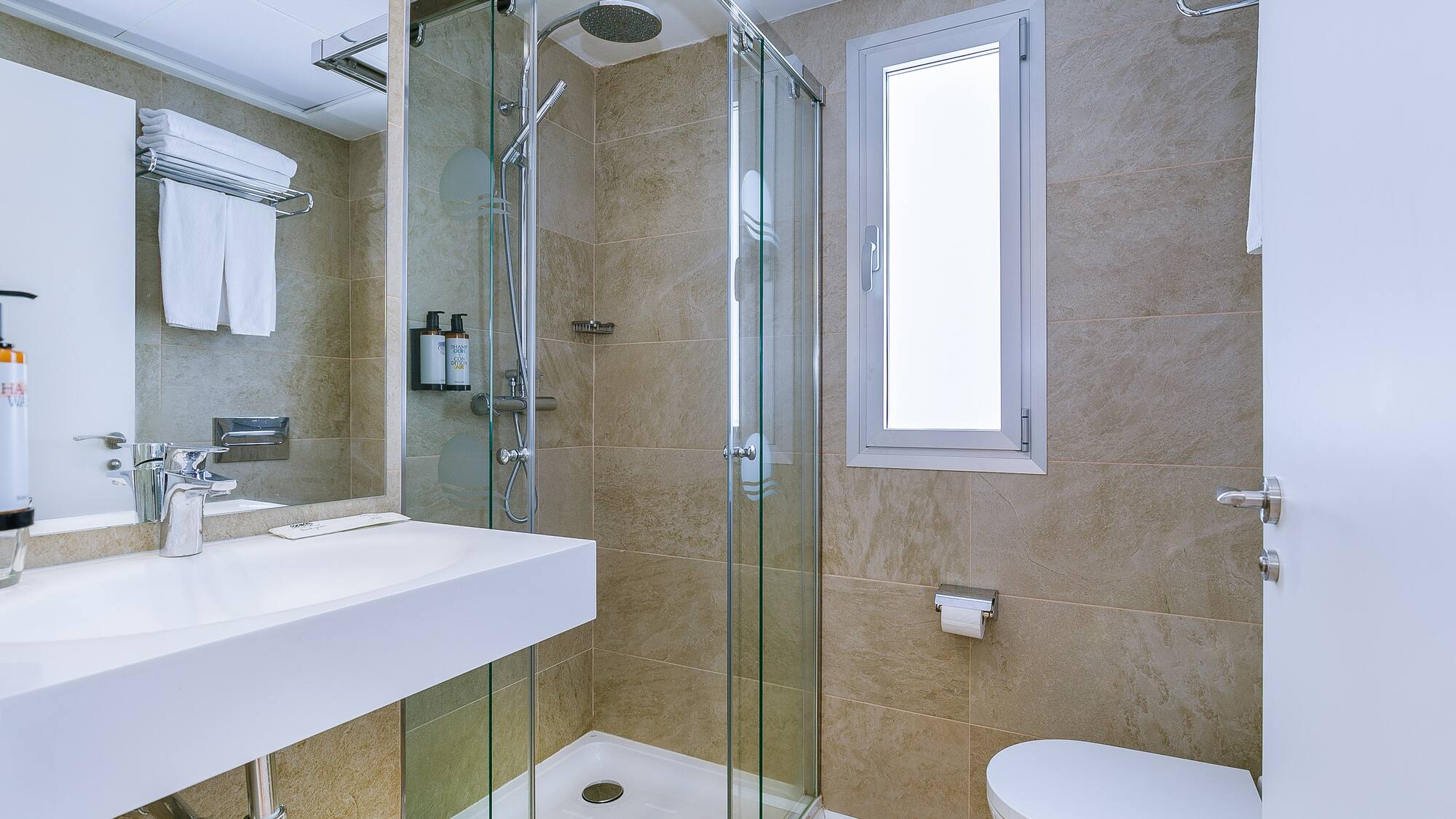 a bathroom with a glass shower and toilet