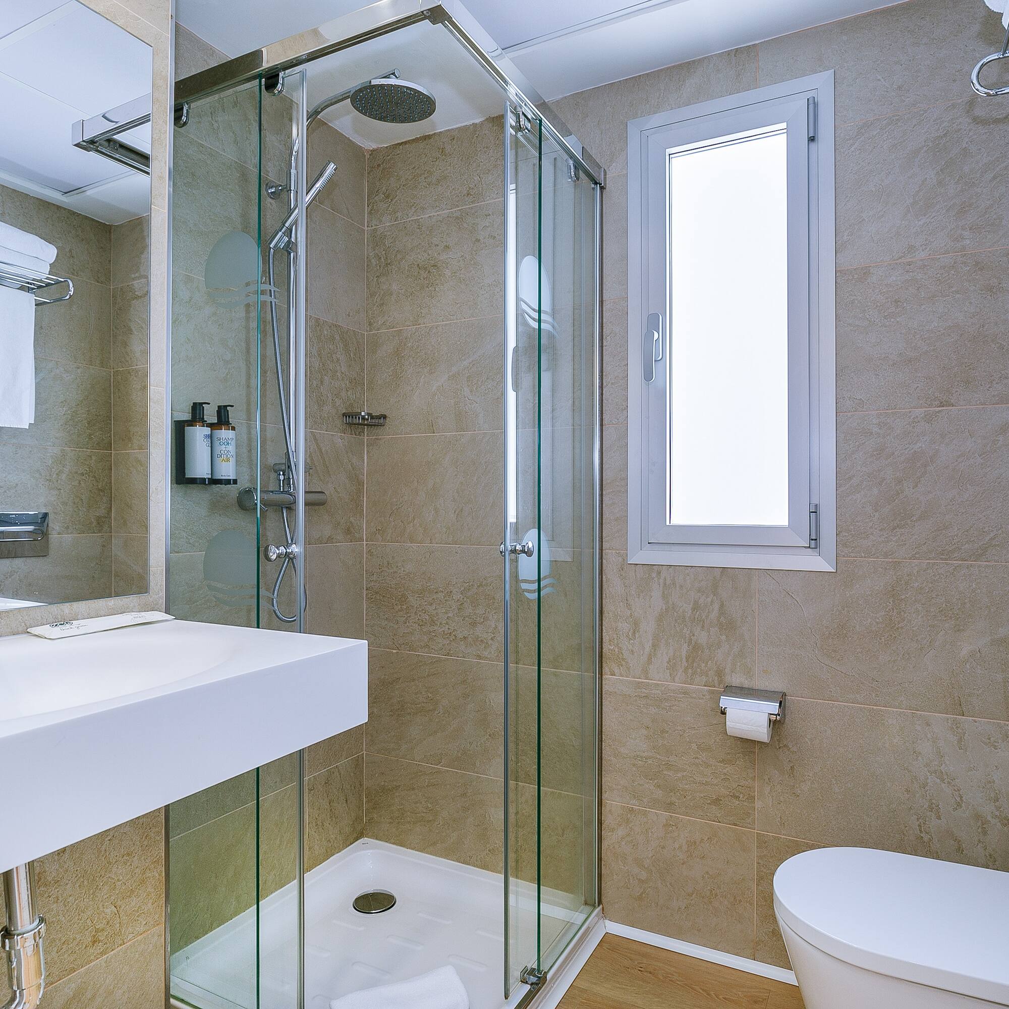 a bathroom with a glass shower and toilet