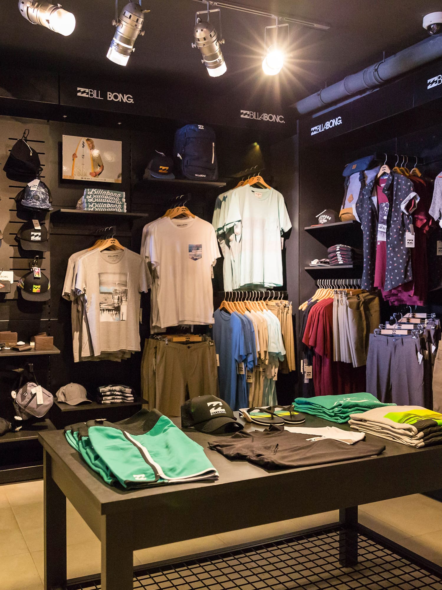 a store with a table with clothes and hats