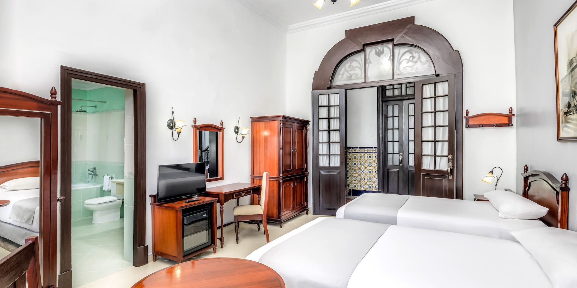 a room with two beds and a desk