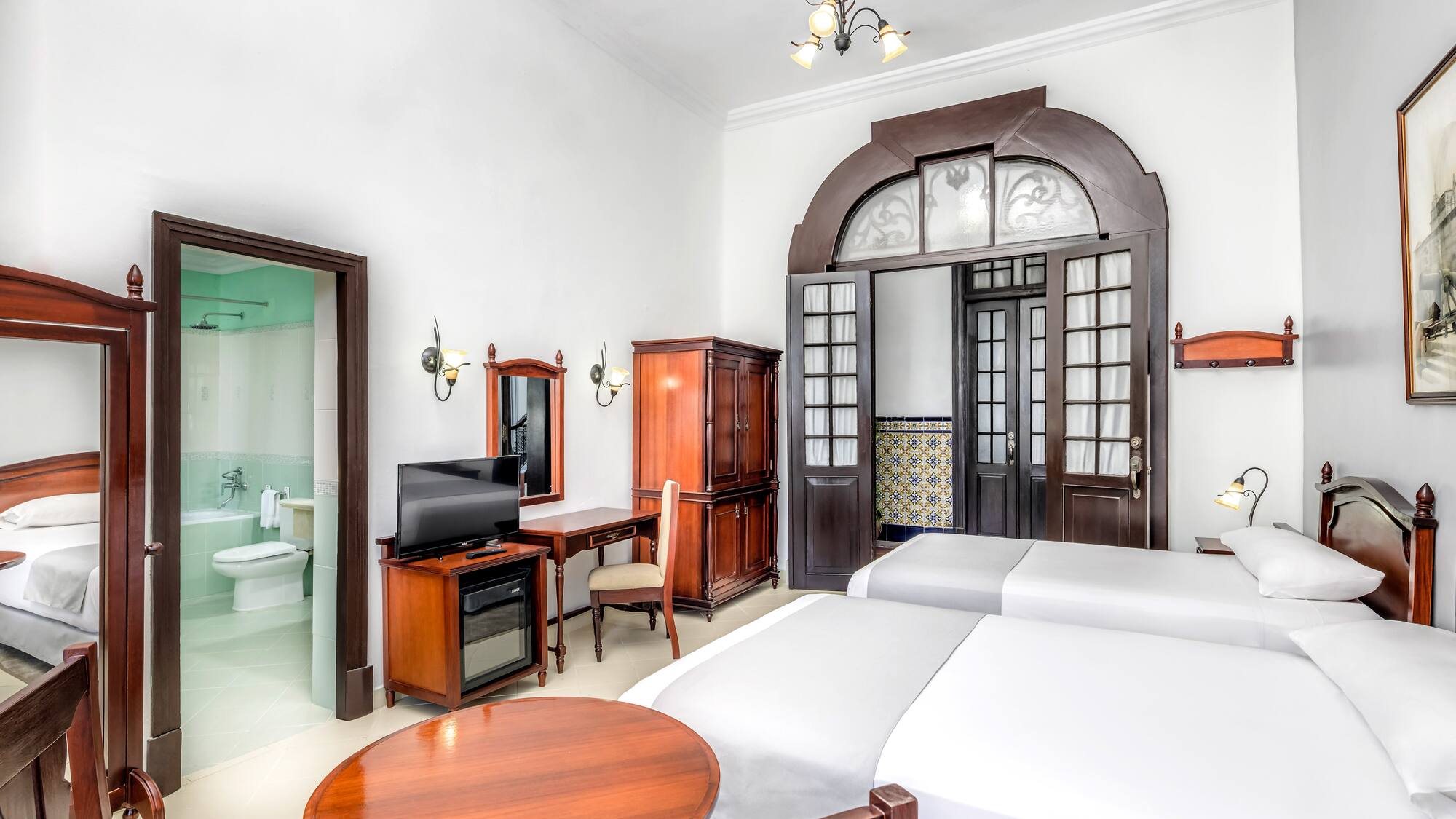 a room with two beds and a desk