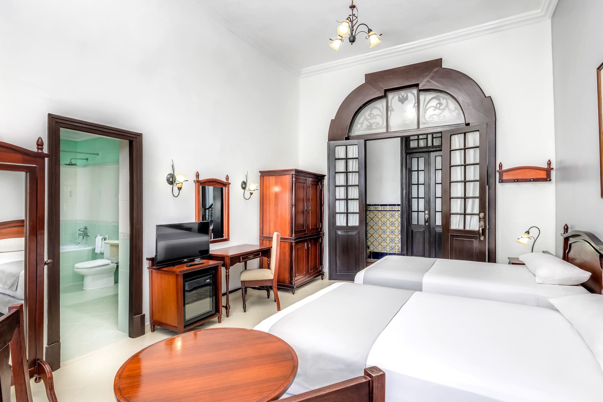 a room with two beds and a desk