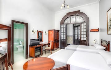 a room with two beds and a desk