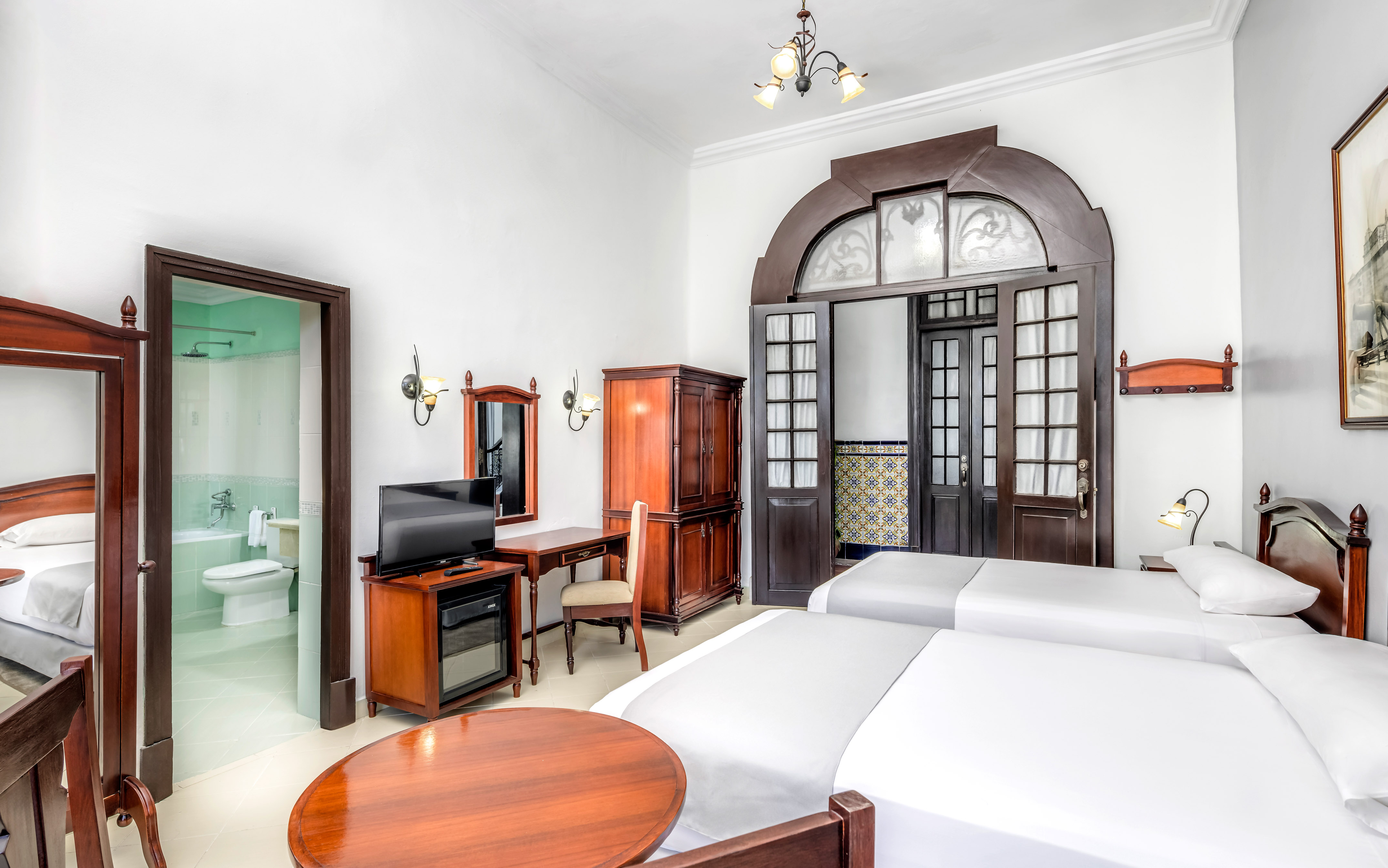 a room with two beds and a desk